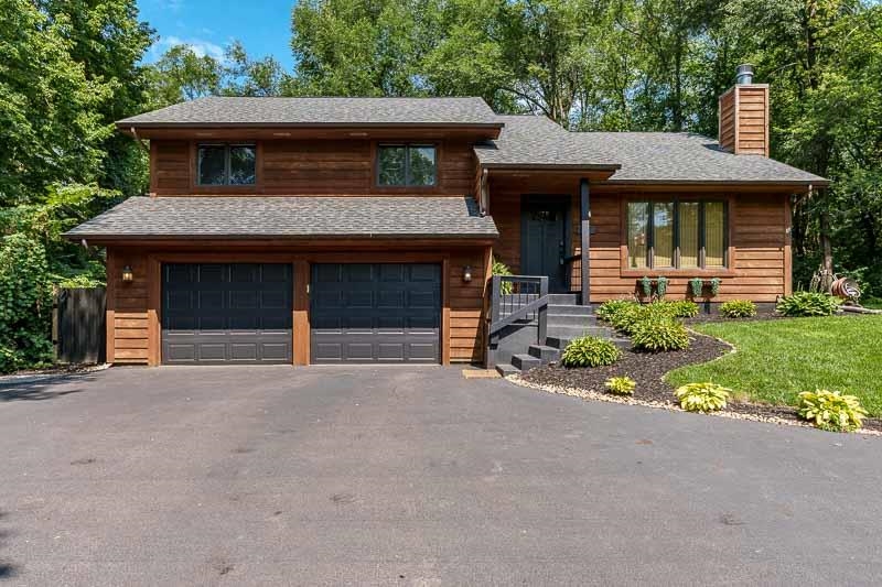 14 Terrace View Boulevard Oregon, IL 61061 - Photo 1 of 50 a front view of a house with a garden and garage