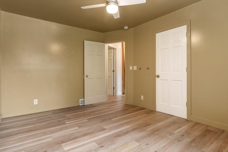 14 Terrace View Boulevard Oregon, IL 61061 - Photo 38 of 50 an empty room with wooden floor and a ceiling fan