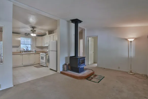 a living room with stainless steel appliances kitchen island granite countertop furniture and a kitchen view