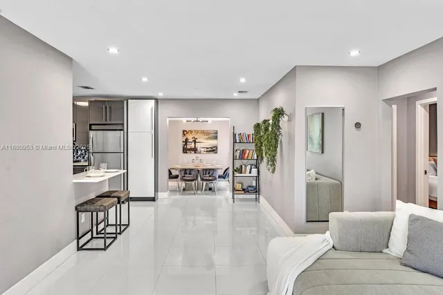 a kitchen with a refrigerator a stove a dining table and chairs