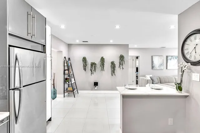 a dining room with furniture and a large window
