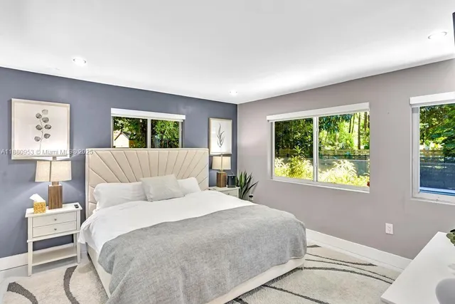 a view of backyard with swimming pool and seating