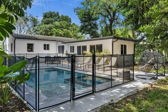 a bedroom with two beds and a large window