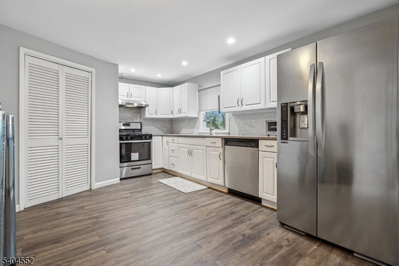 2389 Steuben Street Union, NJ 07083 - Photo 18 of 27 a kitchen with stainless steel appliances granite countertop a refrigerator sink and white cabinets