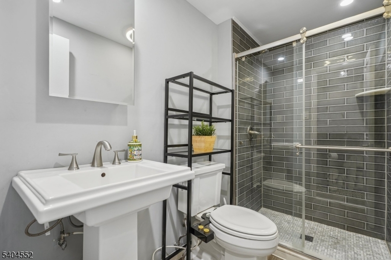 2389 Steuben Street Union, NJ 07083 - Photo 19 of 27 a bathroom with a sink toilet and shower