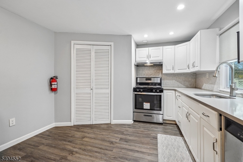 2389 Steuben Street Union, NJ 07083 - Photo 21 of 27 a kitchen with granite countertop a stove and a refrigerator