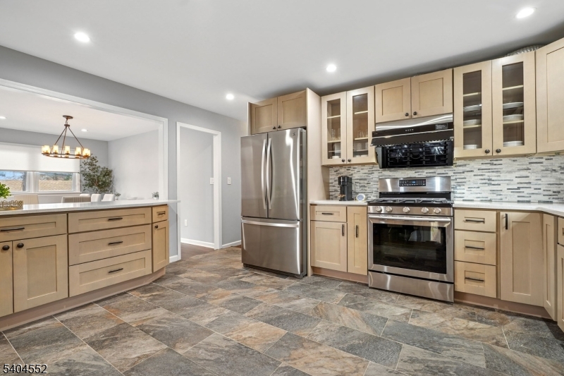 2389 Steuben Street Union, NJ 07083 - Photo 6 of 27 a kitchen with granite countertop a refrigerator stove and oven