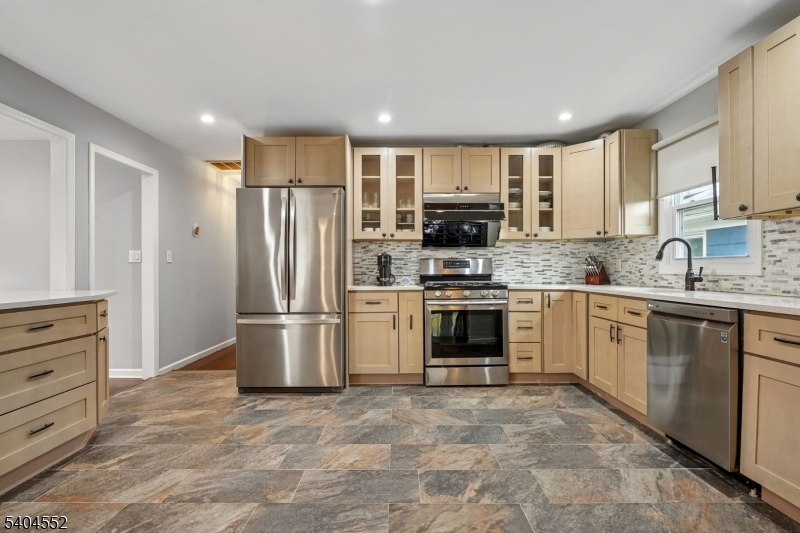 2389 Steuben Street Union, NJ 07083 - Photo 7 of 27 a kitchen with a sink cabinets stainless steel appliances and a window
