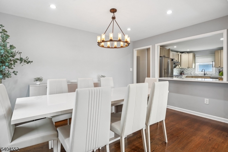 2389 Steuben Street Union, NJ 07083 - Photo 9 of 27 a dining room with furniture a chandelier and wooden floor