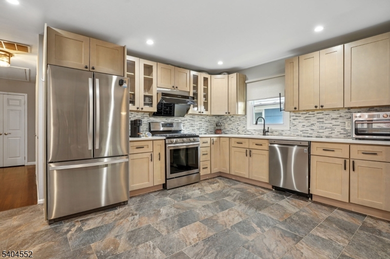 2389 Steuben Street Union, NJ 07083 - Photo 10 of 27 a kitchen with appliances cabinets a sink and a window