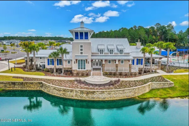 a view of a house with pool and a view of a lake