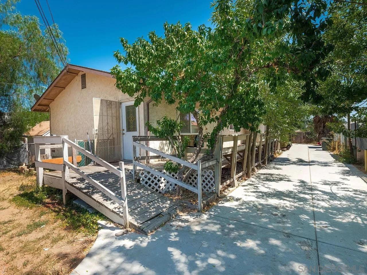 a view of wooden house with a yard