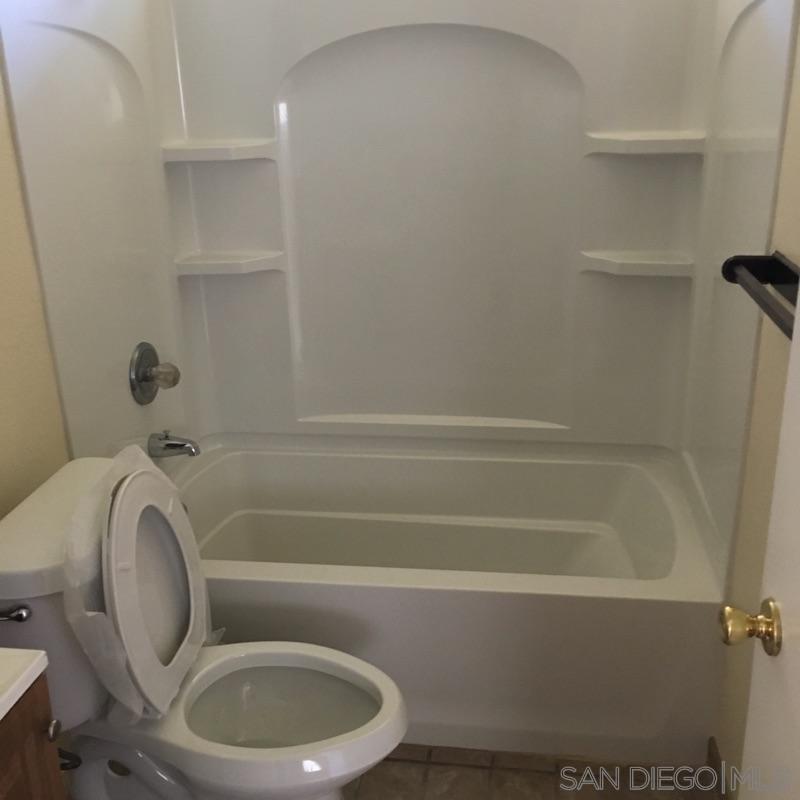 2356 Central Spring Valley Spring Valley, CA 91977 - Photo 11 of 16 a bathroom with a toilet and a bathtub