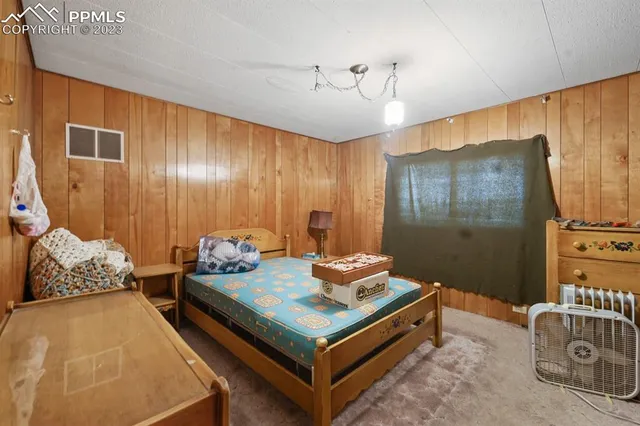 a bedroom with furniture and a chandelier