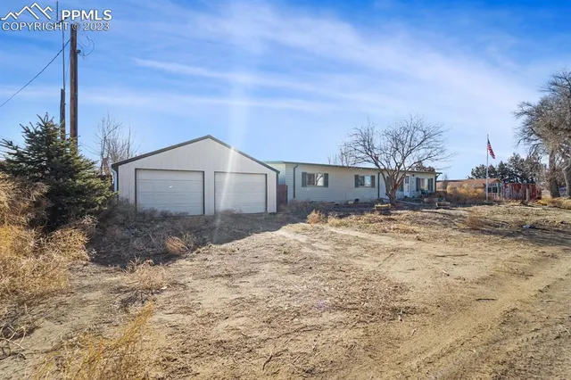 a backyard of a house with large trees