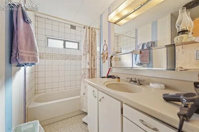 a bathroom with a tub sink and mirror