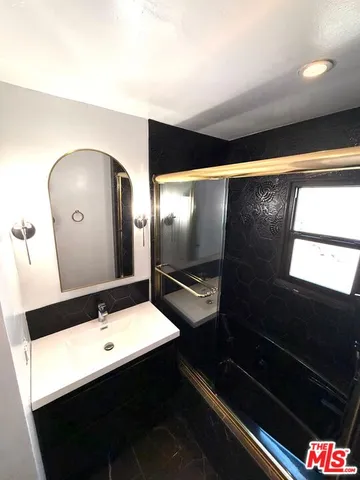 a bathroom with a sink and a mirror