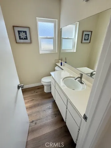 a bathroom with a sink and mirror with toilet