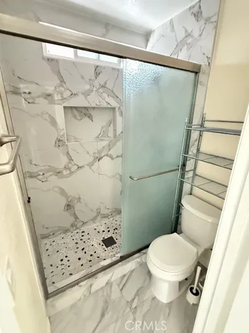 a white toilet sitting next to a shower curtain