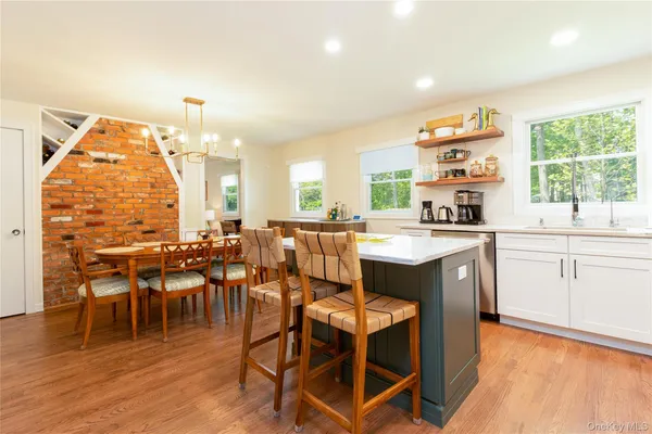 a kitchen with a table chairs and a wooden floor
