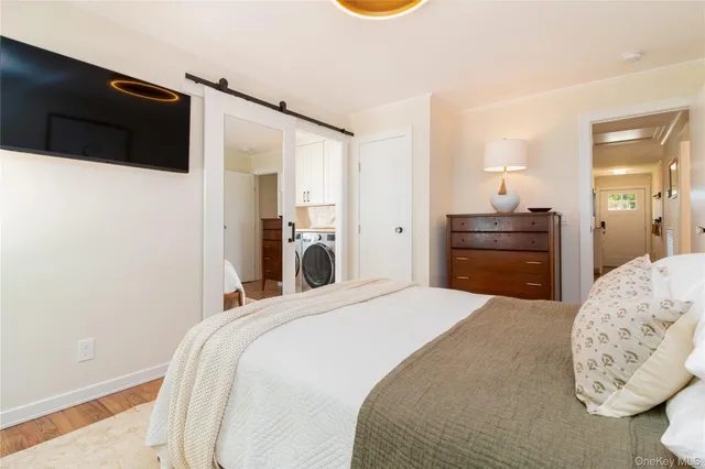 a bedroom with a bed and a flat screen tv