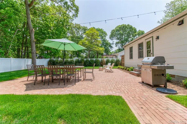 a view of a backyard with sitting area chairs and floor
