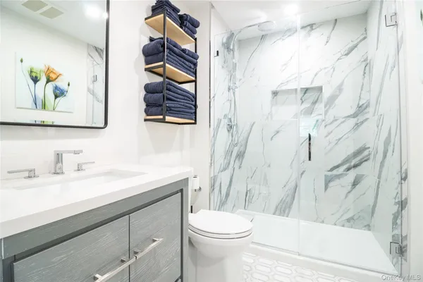 a bathroom with a sink a toilet and a shower curtain