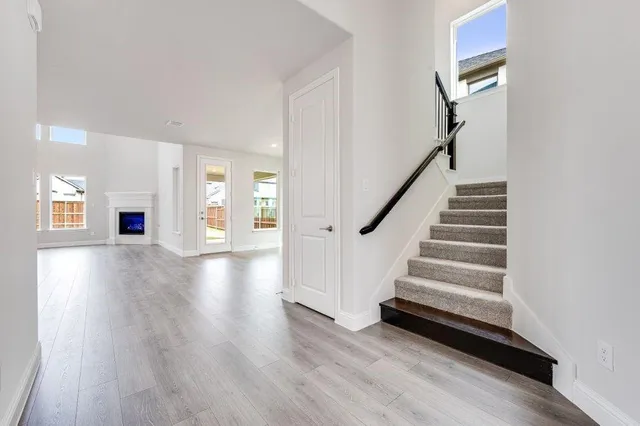 a kitchen with stainless steel appliances granite countertop a sink a stove and a wooden floors
