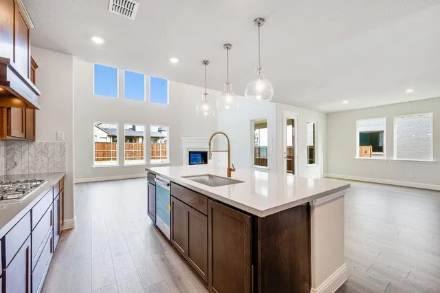 a kitchen with kitchen island a sink counter top space stainless steel appliances and a center island