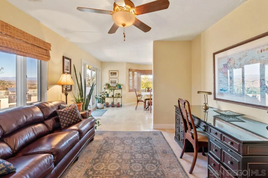16033 Stoney Acres Road Poway, CA 92064 - Photo 17 of 60 a living room with furniture a wooden floor and a chandelier