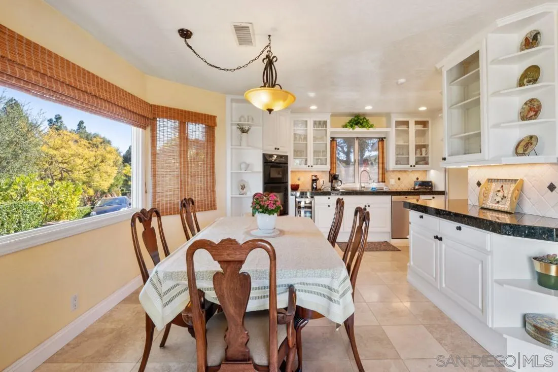 16033 Stoney Acres Road Poway, CA 92064 - Photo 19 of 60 a dining room filled chandelier and wooden floor