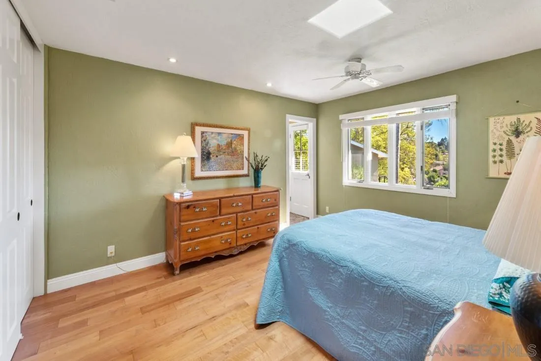 16033 Stoney Acres Road Poway, CA 92064 - Photo 24 of 60 a bedroom with a bed and wooden floor