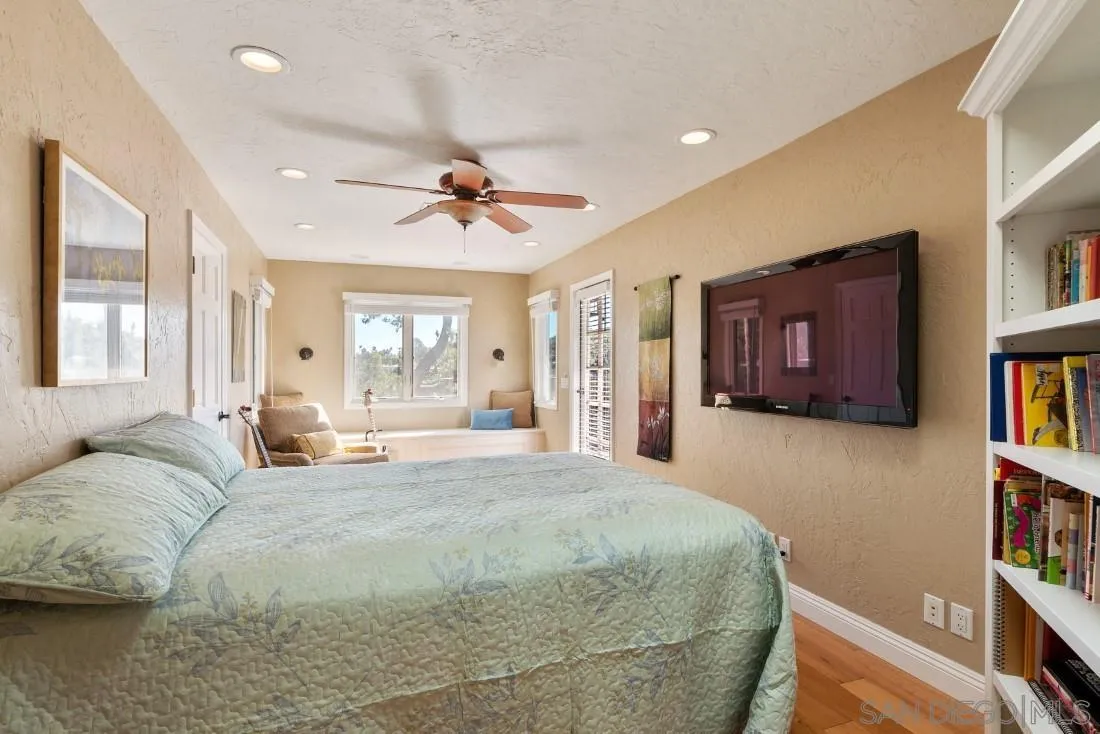 16033 Stoney Acres Road Poway, CA 92064 - Photo 27 of 60 a bed room with a bed and a book shelf