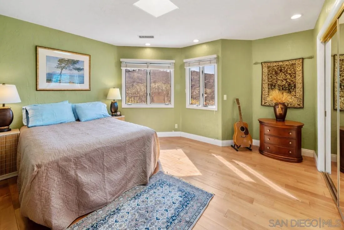 16033 Stoney Acres Road Poway, CA 92064 - Photo 29 of 60 a bedroom with a bed and a couch