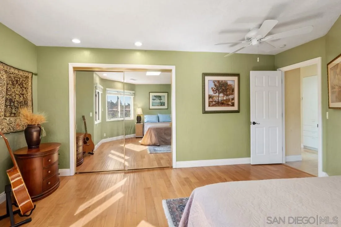 16033 Stoney Acres Road Poway, CA 92064 - Photo 30 of 60 a bedroom with a bed and wooden floor
