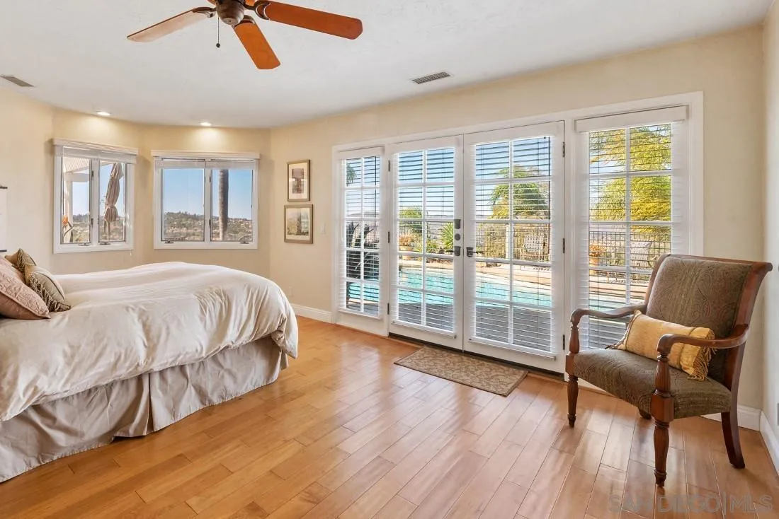 16033 Stoney Acres Road Poway, CA 92064 - Photo 32 of 60 a spacious bedroom with a bed and wooden floor