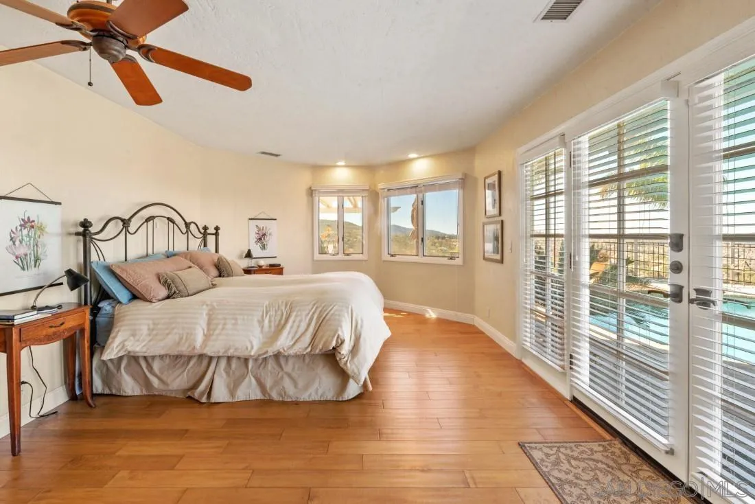 16033 Stoney Acres Road Poway, CA 92064 - Photo 33 of 60 a bedroom with a bed and a large window
