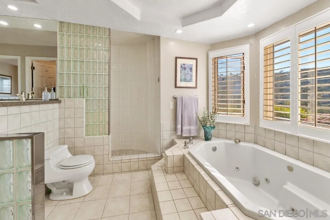 16033 Stoney Acres Road Poway, CA 92064 - Photo 38 of 60 a bathroom with a bathtub and toilet