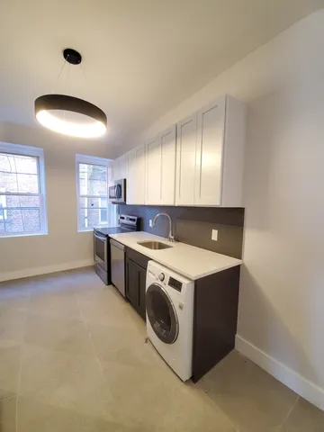 a kitchen that has a lot of cabinets in it
