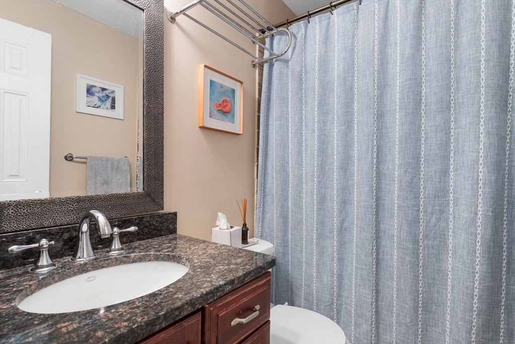 371 Hanover Street, Unit 2 Boston, MA 02113 - Photo 11 of 22 a bathroom with a granite countertop sink and a mirror