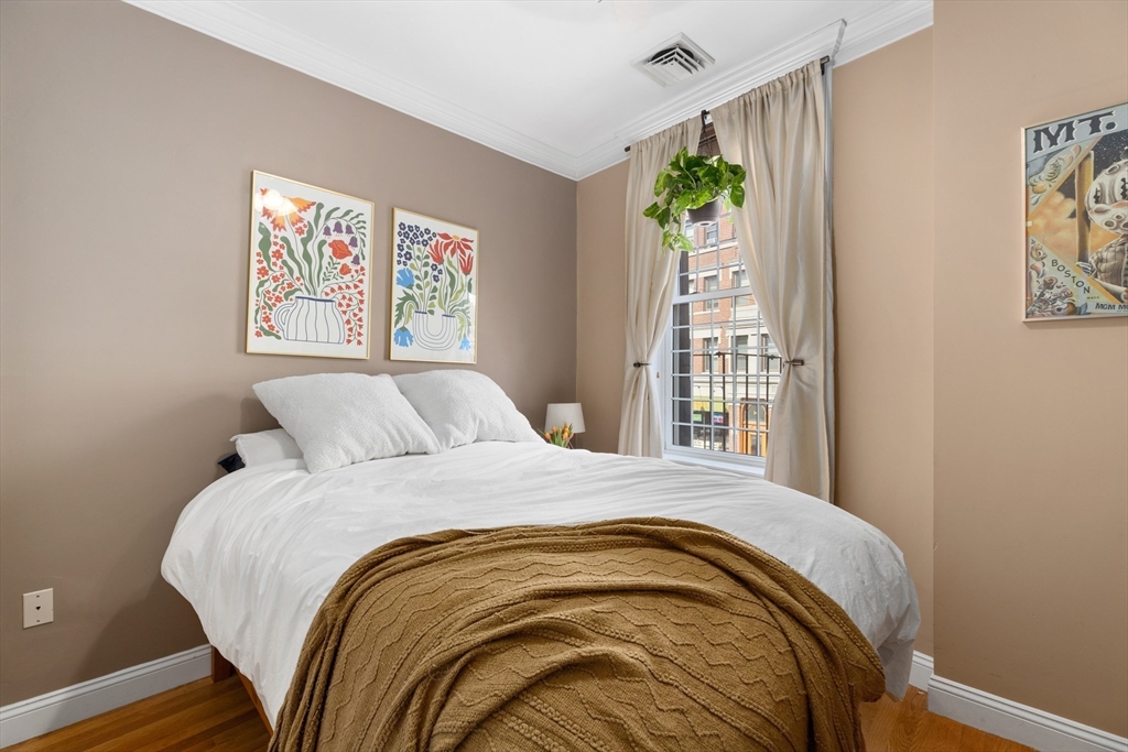 371 Hanover Street, Unit 2 Boston, MA 02113 - Photo 12 of 22 a large bed sitting in a bedroom next to a window
