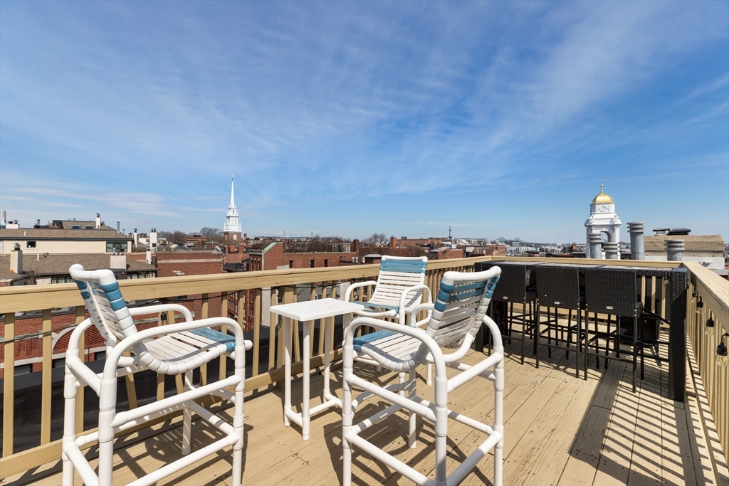 371 Hanover Street, Unit 2 Boston, MA 02113 - Photo 15 of 22 a roof deck with a table and chairs
