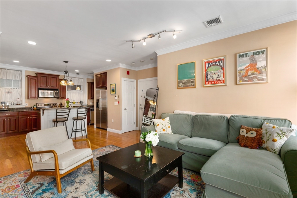 371 Hanover Street, Unit 2 Boston, MA 02113 - Photo 4 of 22 a living room with furniture kitchen view and a table