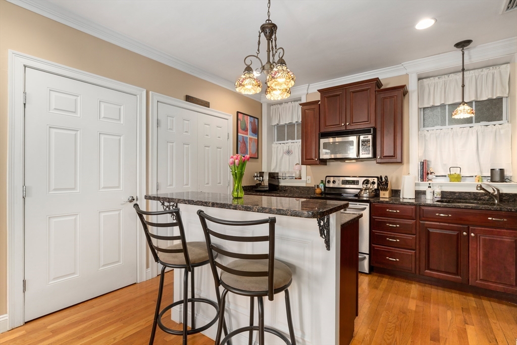 371 Hanover Street, Unit 2 Boston, MA 02113 - Photo 5 of 22 a kitchen with stainless steel appliances granite countertop a stove top oven a sink dishwasher and a microwave