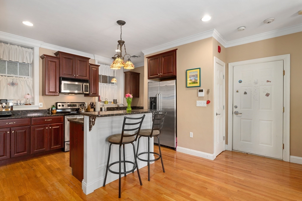 371 Hanover Street, Unit 2 Boston, MA 02113 - Photo 6 of 22 a kitchen with stainless steel appliances granite countertop a refrigerator a stove top oven a sink dishwasher and a refrigerator