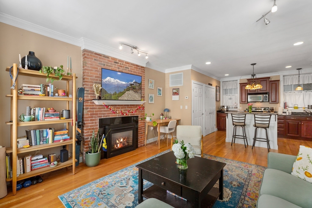 371 Hanover Street, Unit 2 Boston, MA 02113 - Photo 7 of 22 a living room with furniture and a fireplace