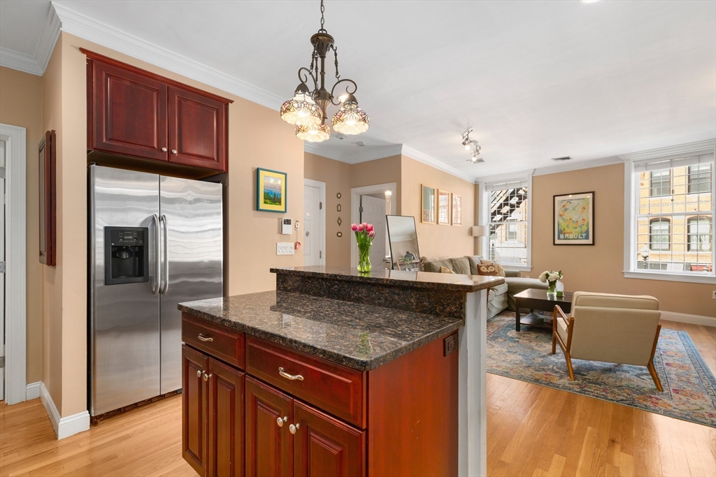 371 Hanover Street, Unit 2 Boston, MA 02113 - Photo 8 of 22 a kitchen with stainless steel appliances granite countertop a stove and a refrigerator