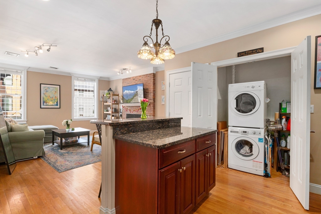 371 Hanover Street, Unit 2 Boston, MA 02113 - Photo 10 of 22 a kitchen with kitchen island granite countertop a stove and a sink