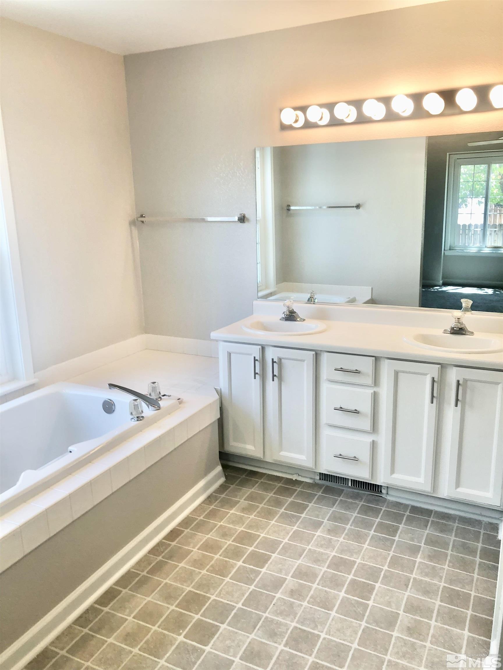 254 Windtree Circle Carson City, NV 89701 - Photo 14 of 23 a bathroom with a tub sink and mirror