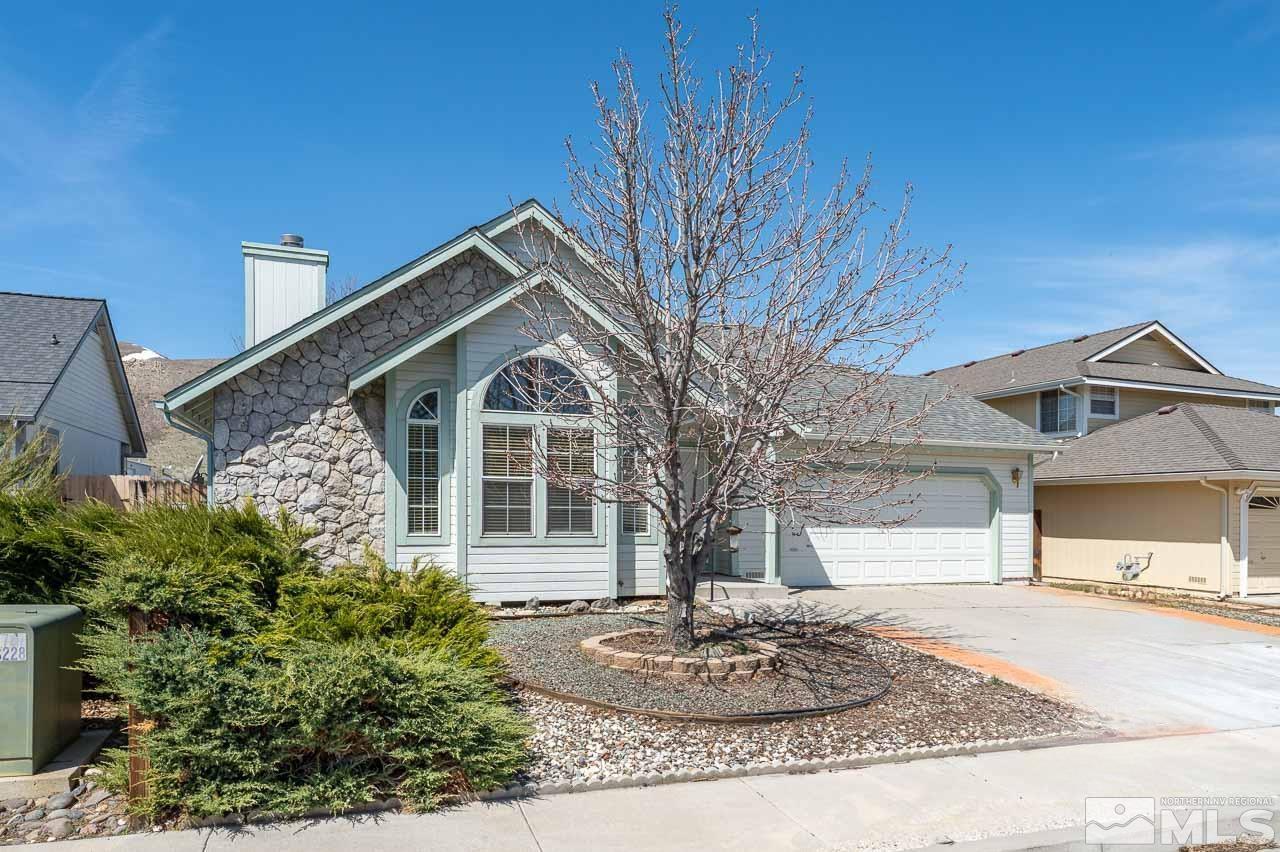 254 Windtree Circle Carson City, NV 89701 - Photo 2 of 23 a front view of a house with a yard and garage